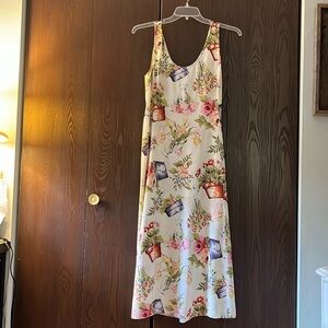 Express sleeveless, maxi dress decorated with flower pots. Size 9/10